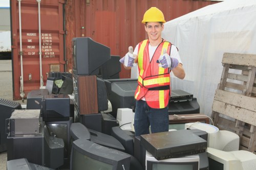 Front view of a commercial waste removal vehicle in a suburban area near Coney Hall